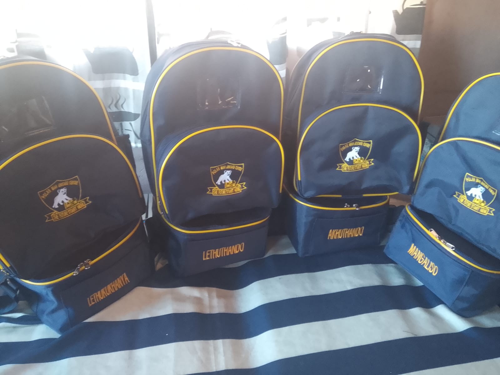 Navy school backpacks with yellow trim and names